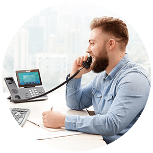 Business man talking on corded desk phone.